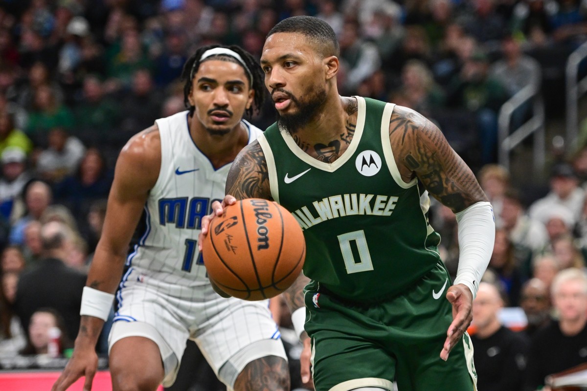 Milwaukee Bucks guard Damian Lillard (0) drives past Orlando Magic guard Gary Harris (14) 